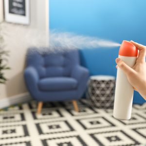 Woman,Spraying,Air,Freshener,At,Home,,Closeup